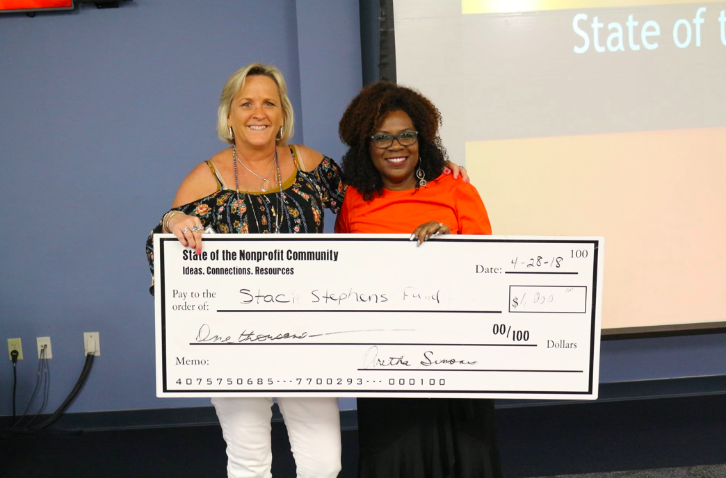 Aretha Simons presenting a grant check at the State of the Nonprofit Community Summit